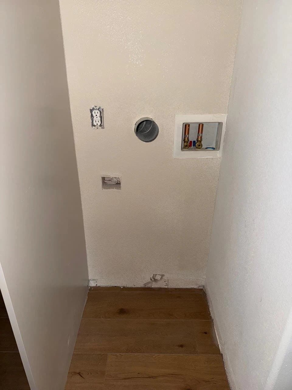 Laundry wall patched around the pipes